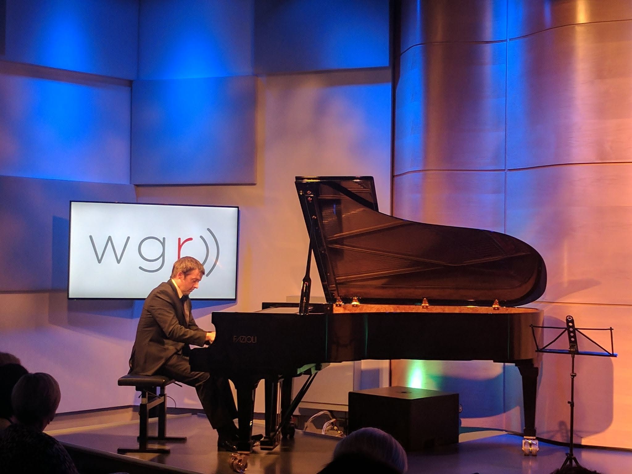 Concert pianist Simon Mulligan performing solo at the grand piano